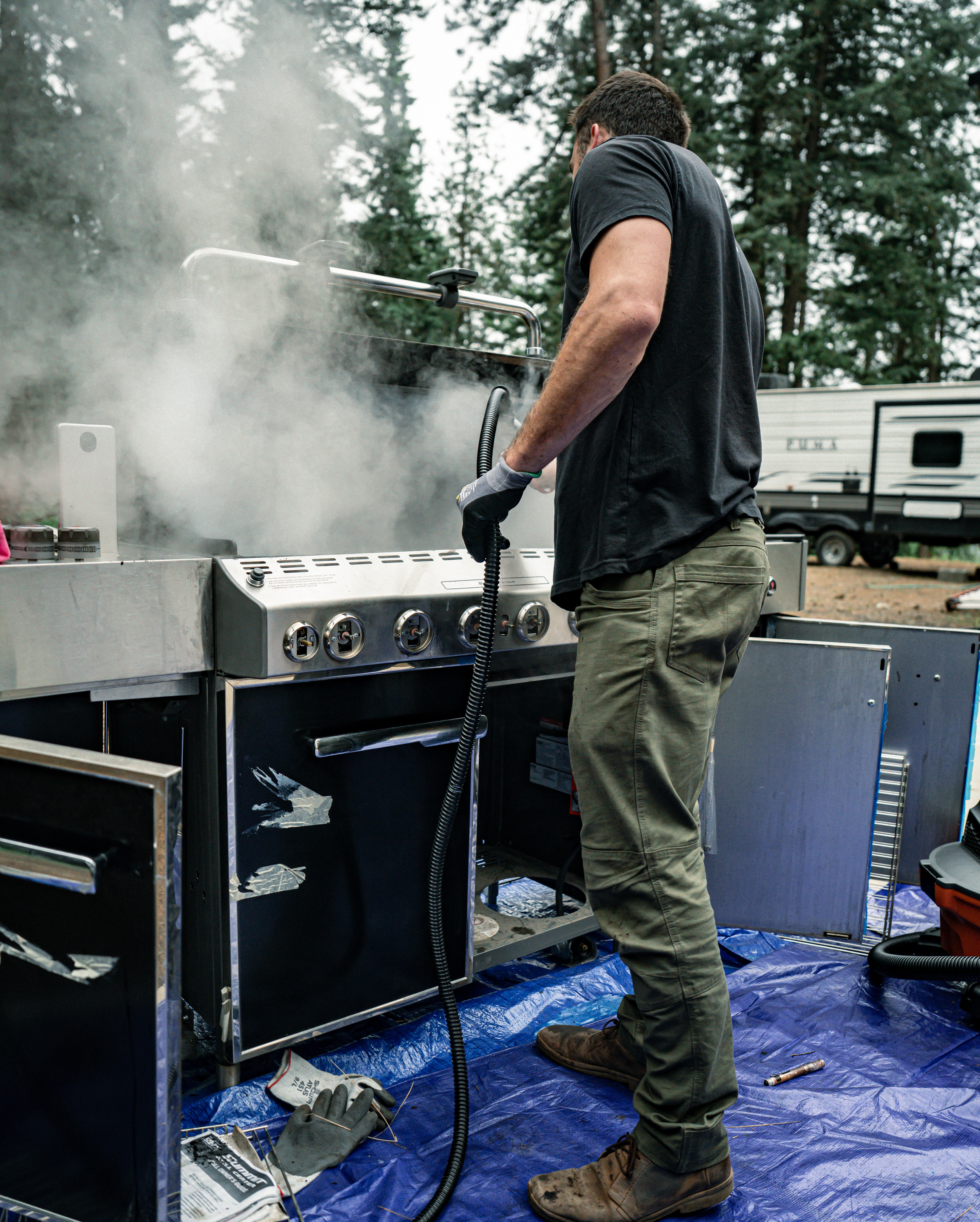 Technician cleaning grill